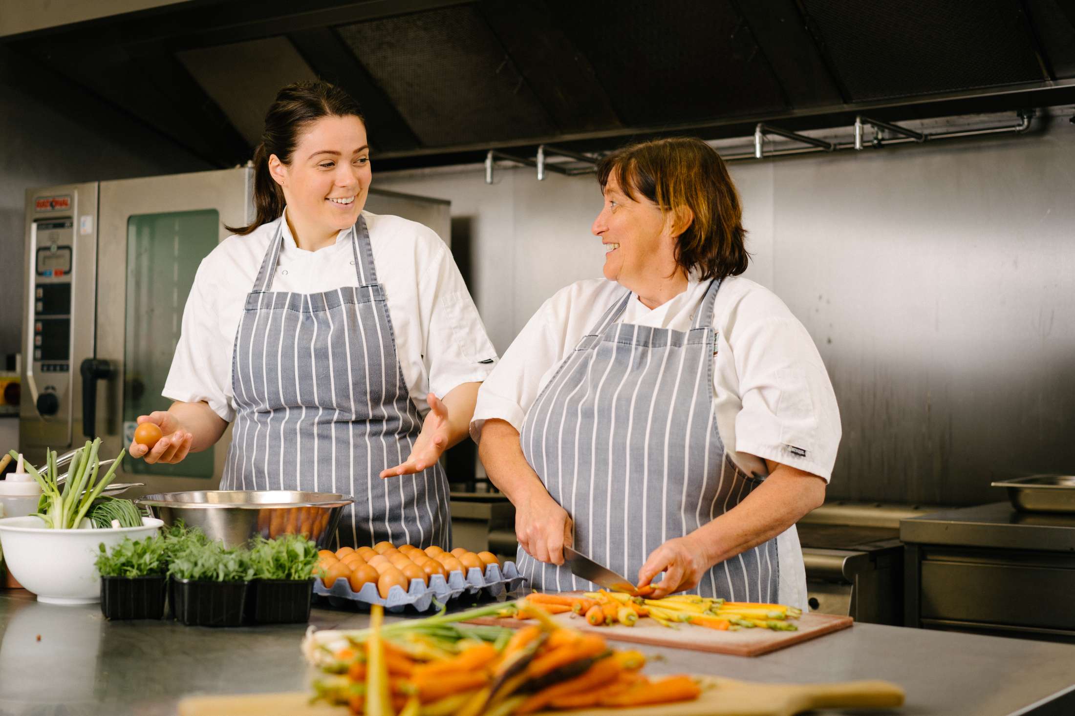 Jane and her daughter preparing vegetables in the kitchen