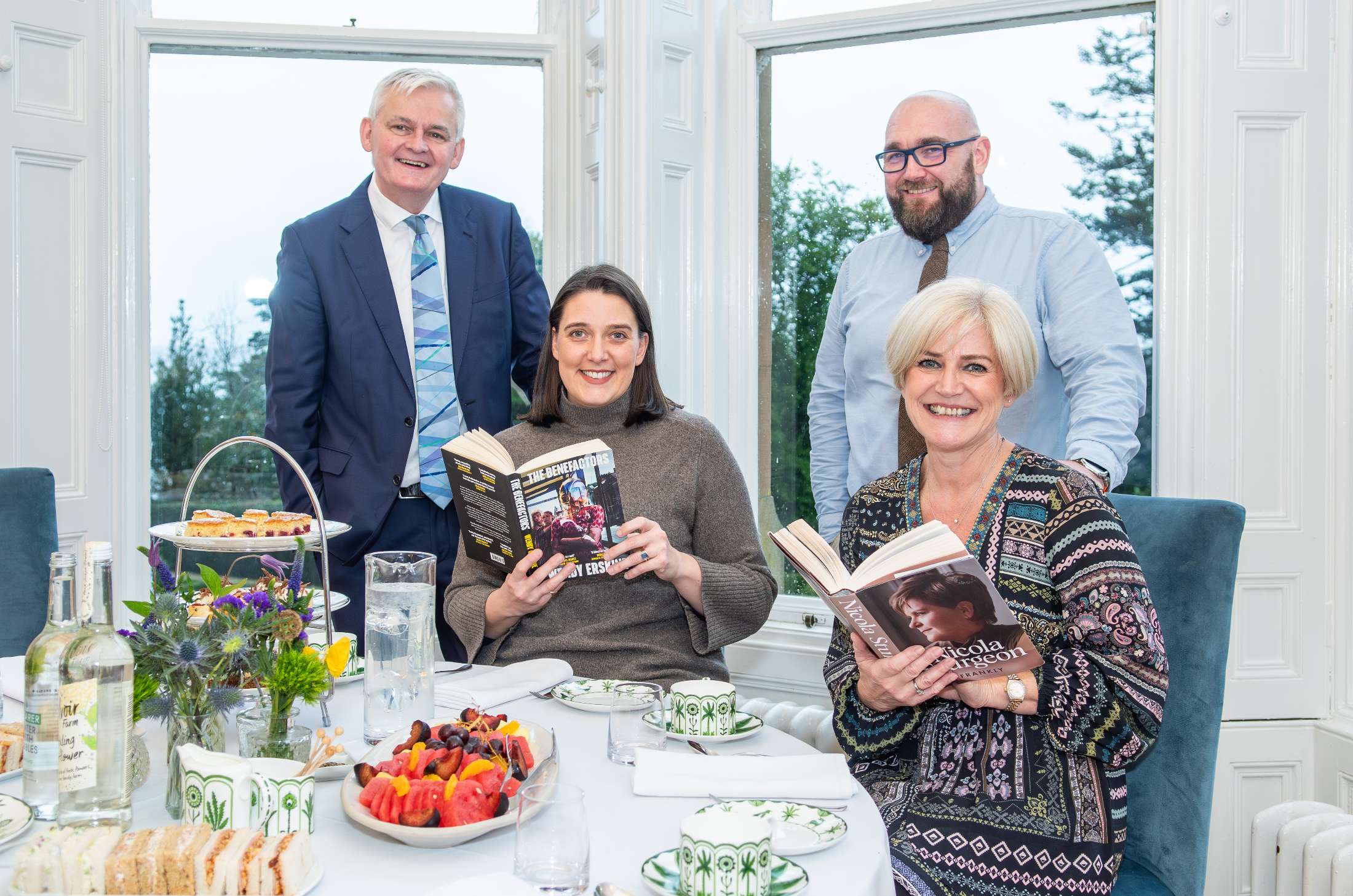 The team at a library event launch with their books